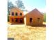 Wood frame of a two-story house under construction with covered porch, on a sunny day with natural surroundings at 107 Oak Rd, Locust Grove, GA 30248