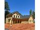 Exterior view of a new two-story home under construction, featuring light yellow siding and a simple roof at 107 Oak Rd, Locust Grove, GA 30248