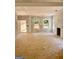 Bright, unfinished living room with a fireplace and large windows, offering a spacious design for Gathering and entertaining at 107 Oak Rd, Locust Grove, GA 30248