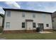 The rear exterior boasts a neutral siding, basement brick work, and access to the backyard at 1124 Pebble Creek Ln, Locust Grove, GA 30248