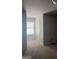 This bedroom boasts neutral carpet, a window letting in light, and a convenient door at 1124 Pebble Creek Ln, Locust Grove, GA 30248