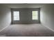 Spacious bedroom featuring neutral paint, plush carpet, and windows with blinds at 1124 Pebble Creek Ln, Locust Grove, GA 30248