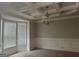 Dining room with coffered ceiling, wainscoting, neutral paint, large windows offering ample natural light at 1124 Pebble Creek Ln, Locust Grove, GA 30248