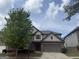 Charming two-story home featuring stone accents, attached two-car garage, and well-maintained landscaping at 1124 Pebble Creek Ln, Locust Grove, GA 30248