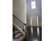 Foyer with soaring ceilings, hardwood floors, carpeted staircase, and elegant trim detailing with lots of sunlight at 1124 Pebble Creek Ln, Locust Grove, GA 30248