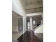 Spacious foyer boasts soaring ceilings, elegant staircase with dark hardwood flooring, and bright, neutral paint at 1124 Pebble Creek Ln, Locust Grove, GA 30248