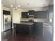 Modern kitchen featuring stainless appliances, granite countertops, dark cabinets, and central island with bar seating at 1124 Pebble Creek Ln, Locust Grove, GA 30248
