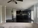 Open kitchen features dark cabinetry, stainless steel appliances, granite countertops and large center island at 1124 Pebble Creek Ln, Locust Grove, GA 30248