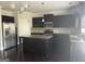 Modern kitchen features stainless appliances, granite countertops, dark cabinetry, and center island for food prep at 1124 Pebble Creek Ln, Locust Grove, GA 30248