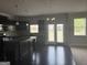 Well-appointed kitchen with black cabinets, granite countertops, stainless appliances, an island, and a breakfast area at 1124 Pebble Creek Ln, Locust Grove, GA 30248