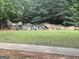 A serene water feature cascading over rocks, nestled within lush landscaping and greenery at 1124 Pebble Creek Ln, Locust Grove, GA 30248