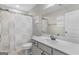Neutral bathroom featuring a white vanity, shower with patterned curtain and a large mirror at 19 Mediterranean Ave # 506, Sharpsburg, GA 30277