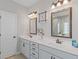 Bright bathroom with double vanity, framed mirrors, and modern lighting fixtures at 19 Mediterranean Ave # 506, Sharpsburg, GA 30277