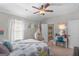 Bright bedroom with ceiling fan, window, hammock chair, and adjacent bathroom visible at 19 Mediterranean Ave # 506, Sharpsburg, GA 30277