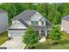 Charming home featuring a well-manicured front lawn, a two-car garage, and classic architectural details at 19 Mediterranean Ave # 506, Sharpsburg, GA 30277