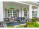 Welcoming front porch with comfortable seating, swing, stone accents, and decorative plants at 19 Mediterranean Ave # 506, Sharpsburg, GA 30277