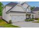 Attractive home exterior with a two-car garage, manicured landscaping, and inviting front porch at 19 Mediterranean Ave # 506, Sharpsburg, GA 30277
