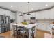 Bright kitchen with white cabinets, stainless steel appliances, and a large center island with pendant lighting at 19 Mediterranean Ave # 506, Sharpsburg, GA 30277
