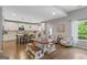 Open-concept kitchen features white cabinets, modern appliances, and a large central island with counter seating at 19 Mediterranean Ave # 506, Sharpsburg, GA 30277