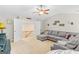 Living room with ceiling fan, large sectional sofa, and adjacent staircase visible through doorway at 19 Mediterranean Ave # 506, Sharpsburg, GA 30277