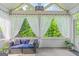 Relaxing sunroom with a comfortable seating area, airy curtains, and views of the lush greenery at 19 Mediterranean Ave # 506, Sharpsburg, GA 30277