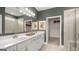 Bathroom featuring double sinks, a large mirror, and a glass-enclosed shower, offering a clean and modern design at 604 Parnassus Rd # 05, Locust Grove, GA 30248