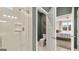 Bathroom with glass-enclosed shower, and a view to a bedroom space beyond an open door at 604 Parnassus Rd # 05, Locust Grove, GA 30248