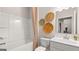 Bright bathroom featuring a shower-tub combo, vanity, and decorative rattan wall decor at 604 Parnassus Rd # 05, Locust Grove, GA 30248
