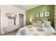 Charming bedroom featuring neutral decor, with a decorative bench, and verdant walls at 604 Parnassus Rd # 05, Locust Grove, GA 30248