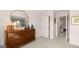 Modern bedroom showcasing a dark wood dresser, a round mirror, and decorative frogs at 604 Parnassus Rd # 05, Locust Grove, GA 30248