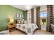 Inviting bedroom with a large bed, stylish lamps, curtains, and verdant colored walls at 604 Parnassus Rd # 05, Locust Grove, GA 30248