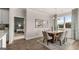Dining room showcasing an elegant chandelier, modern artwork, and seamless flow to the nearby kitchen and living areas at 604 Parnassus Rd # 05, Locust Grove, GA 30248