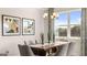 Elegant dining room featuring a modern light fixture and a large window that provides natural light and scenic views at 604 Parnassus Rd # 05, Locust Grove, GA 30248