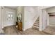 Welcoming foyer with stylish decor, a staircase leading upstairs, and convenient access to the entryway and storage areas at 604 Parnassus Rd # 05, Locust Grove, GA 30248
