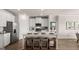 Modern kitchen featuring stainless steel appliances, white cabinets, island with breakfast bar, and wood-style flooring at 604 Parnassus Rd # 05, Locust Grove, GA 30248