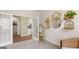 Stylish living room with white french doors, gray carpet, and art decorations on the wall at 604 Parnassus Rd # 05, Locust Grove, GA 30248