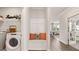 Inviting mudroom with a built-in bench, decorative pillows, and easy access to the laundry area and main living spaces at 604 Parnassus Rd # 05, Locust Grove, GA 30248