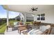 Inviting outdoor patio with plush seating, ceiling fan, and views of the backyard at 604 Parnassus Rd # 05, Locust Grove, GA 30248