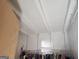 Bright attic space with white ceiling beams, storage, and clothes hanging on a rack at 309 Cornish Mountain Rd, Covington, GA 30014