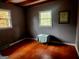 Bedroom with gray walls, hardwood floors, and two windows letting in natural light at 309 Cornish Mountain Rd, Covington, GA 30014