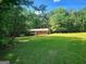 Secluded property with a well-maintained lawn and treelined backdrop at 309 Cornish Mountain Rd, Covington, GA 30014