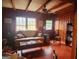 Cozy living room with wood paneling, a ceiling fan, a comfortable sofa, and a wood bookcase at 309 Cornish Mountain Rd, Covington, GA 30014