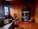 Cozy living room with wood-paneled walls, comfortable seating, and a charming rocking chair by the bookshelf at 309 Cornish Mountain Rd, Covington, GA 30014