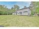 Wide shot of large backyard with newly installed sod and black metal fence. A few trees provide some shade at 400 Walnut Grove Rd, Peachtree City, GA 30269
