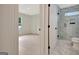 Entry way to a bathroom featuring a marble shower, hardwood floors, and modern white fixtures at 400 Walnut Grove Rd, Peachtree City, GA 30269