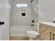 Clean bathroom featuring modern tiling, a tub with shower, and a stylish vanity with marble countertop at 400 Walnut Grove Rd, Peachtree City, GA 30269