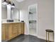 Bathroom with modern vanity and fixtures and walk in closet with shelving at 400 Walnut Grove Rd, Peachtree City, GA 30269