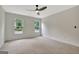 Bright bedroom featuring neutral walls, carpet, ceiling fan, and two windows providing natural light at 400 Walnut Grove Rd, Peachtree City, GA 30269