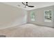 Spacious bedroom boasting neutral carpet, natural light from two windows, and a modern ceiling fan at 400 Walnut Grove Rd, Peachtree City, GA 30269