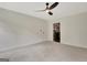 Bedroom featuring neutral carpet, a ceiling fan, a bathroom door, and natural light through windows at 400 Walnut Grove Rd, Peachtree City, GA 30269
